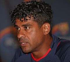 A man wearing a blue and red shirt.